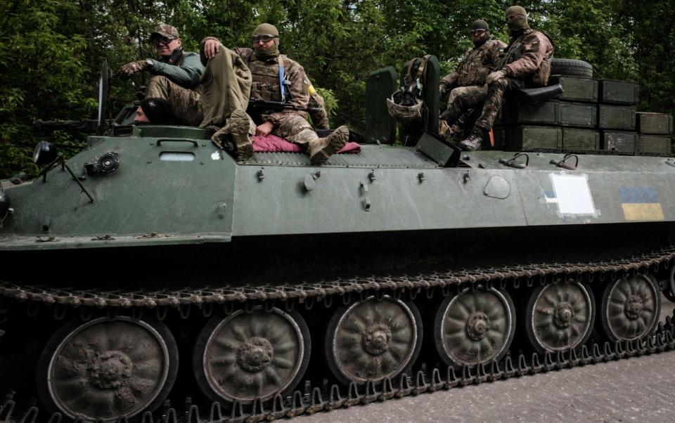 TOPSHOT - Ukrainian soldiers ride on a light armored multi-purpose towing vehicle near Bakhmut, eastern Ukraine, on May 15, 2022, amid the Russian invasion of Ukraine. (Photo by Yasuyoshi CHIBA / AFP) (Photo by YASUYOSHI CHIBA/AFP via Getty Images) - Photo by YASUYOSHI CHIBA/AFP via Getty Images