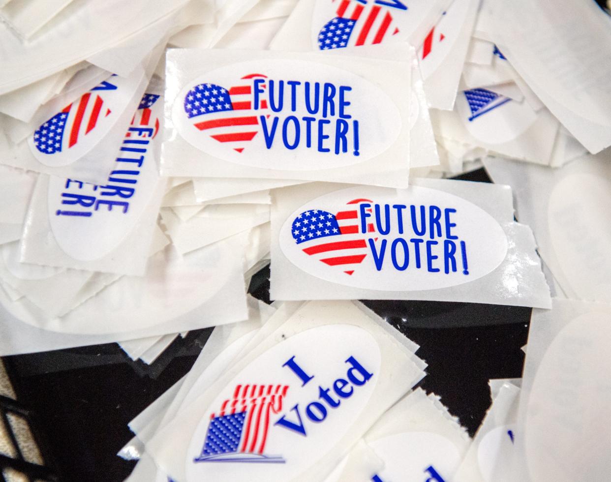 A stack of voting stickers for kids lie alongside the voting age version at a polling place Tuesday, April 6 2021 at First English Lutheran Church in Peoria.
