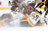 Nashville Predators' goalie Juuse Saros (74) is crashed into by Edmonton Oilers' Warren Foegele (37) and Predators' Roman Josi (59) during the second period of an NHL hockey game, Thursday, Jan. 27, 2022 in Edmonton, Alberta. (Jason Franson/The Canadian Press via AP)