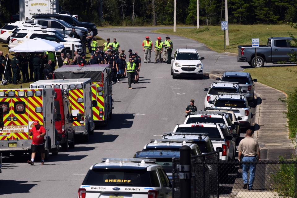 Law enforcement and emergency vehicles line the road to Mossy Head School during an active shooter training exercise held Friday.