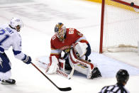 A shot on the goal by Tampa Bay Lightning center Brayden Point (21) bounces off the post as Florida Panthers goaltender Chris Driedger (60) defends during the third period of an NHL hockey game, Monday, May 10, 2021, in Sunrise, Fla. (AP Photo/Lynne Sladky)