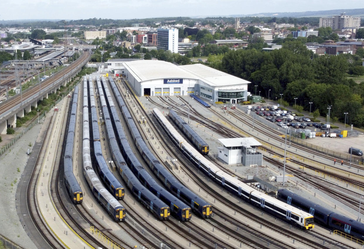 Southeastern trains sit in sidings during a nationwide train strike, in Ashford, England, Tuesday June 21, 2022. Tens of thousands of railway workers have walked off the job in Britain, bringing the train network to a crawl in the country’s biggest transit strike in three decades. (Gareth Fuller/PA via AP)