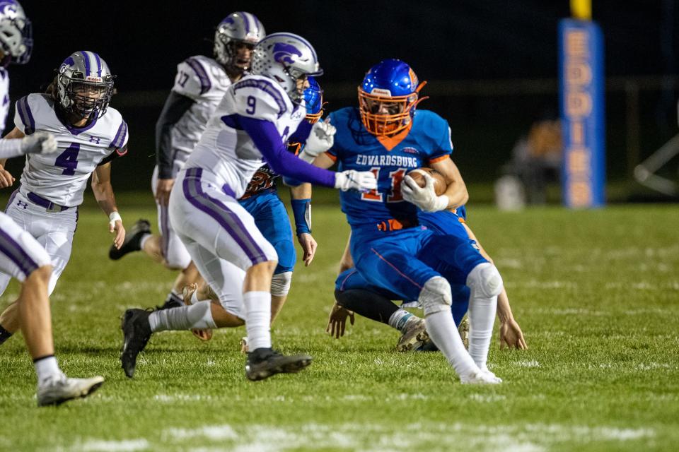 Edwardsburg's Logan McColley runs with the ball for yardage as Three Rivers' Tre Rohrer pursues during the Three Rivers-Edwardsburg high school football game on Friday, November 05, 2021, at Leo Hoffman Field in Edwardsburg, Michigan.