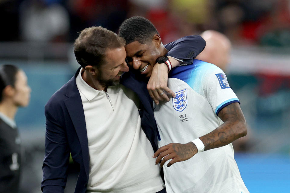 England manager Gareth Southgate (left) hugs Marcus Rashford as he is substituted after scoring two goals in the World Cup match against Wales. 