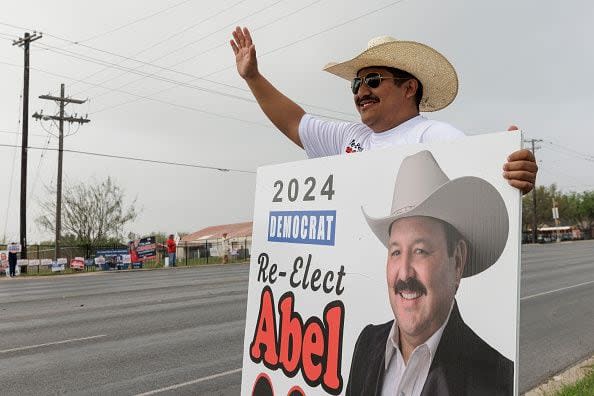 BROWNSVILLE, TEXAS - MARCH 5: Manny Maldonado holds a campaign sign for a constable candidate across the street from a polling place on March 5, 2024 in Brownsville, Texas. 15 States and one U.S. Territory hold their primary elections on Super Tuesday, awarding more delegates than any other day in the presidential nominating calendar.  (Photo by Michael Gonzalez/Getty Images)
