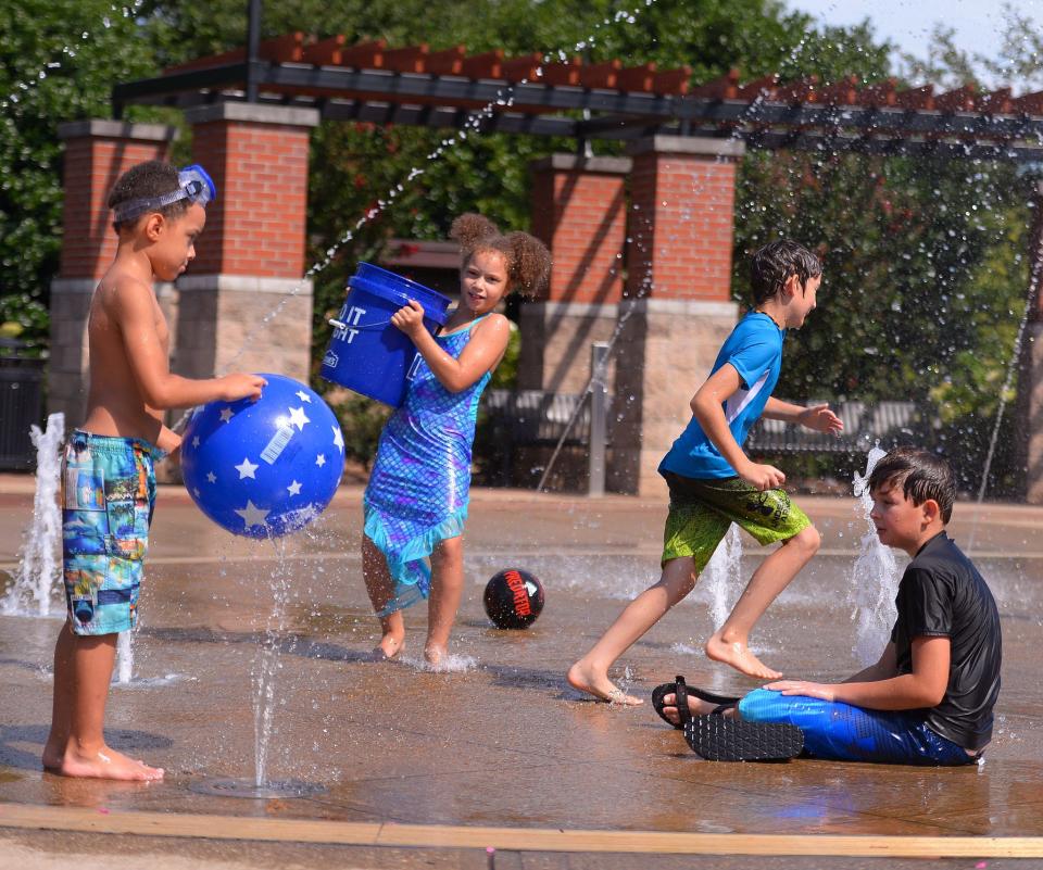 Homeschool parents, including Amber Breeze and Wendy McCarty, watch their children play at the Barnet Park splash pad in Spartanburg, Thursday, August 19, 2021. Micah Breeze, 7, Michaela Breeze, 8, Harper McCarty, 8, and Ayden McCarty, 11, play together at the park.