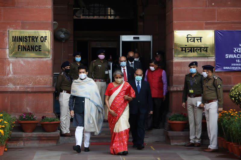 India's Finance Minister Nirmala Sitharaman and Minister of State for Finance and Corporate Affairs Anurag Thakur walk as she leaves her office to present the federal budget in the parliament in New Delhi
