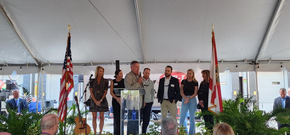 Cheney Brothers CEO Byron Russell, with members of his family behind him, addresses the crowd at the grand opening of a new facility in Port St. Lucie on Jan. 30, 2024.