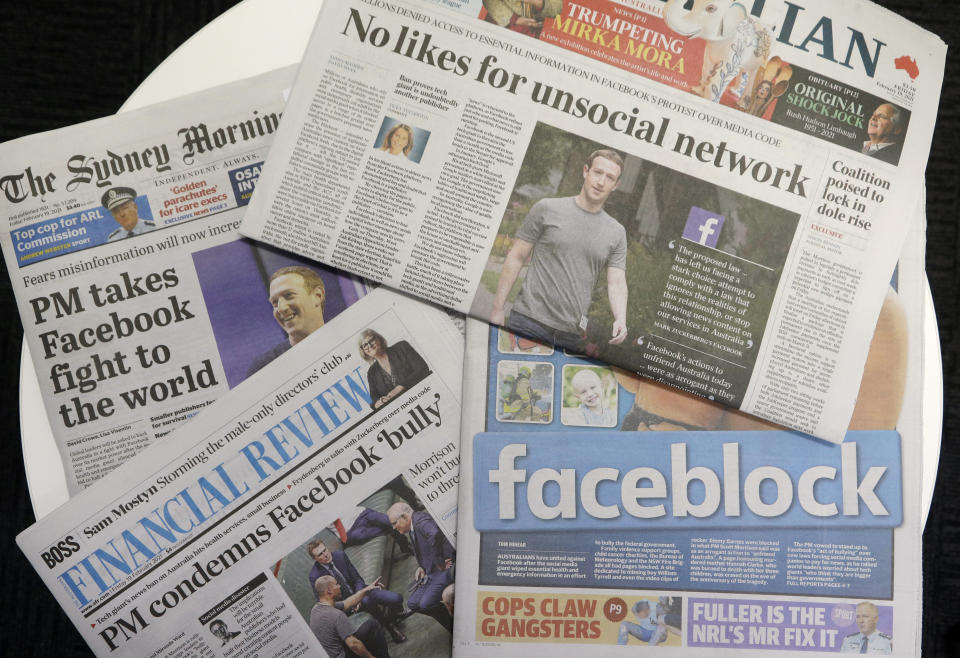 Front pages of Australian newspapers are displayed featuring stories about Facebook in Sydney, Friday, Feb. 19, 2021. In a surprise retaliatory move Thursday, Facebook blocked Australians from sharing news stories, escalating a fight with the government over whether powerful tech companies should have to pay news organizations for content. (AP Photo/Rick Rycroft)