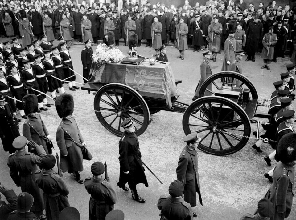 The last solemn journey of King George VI, when his coffin was pulled on ropes by sailors in procession from Windsor railway station to the funeral service in St George’s Chapel (PA) (PA Archive)