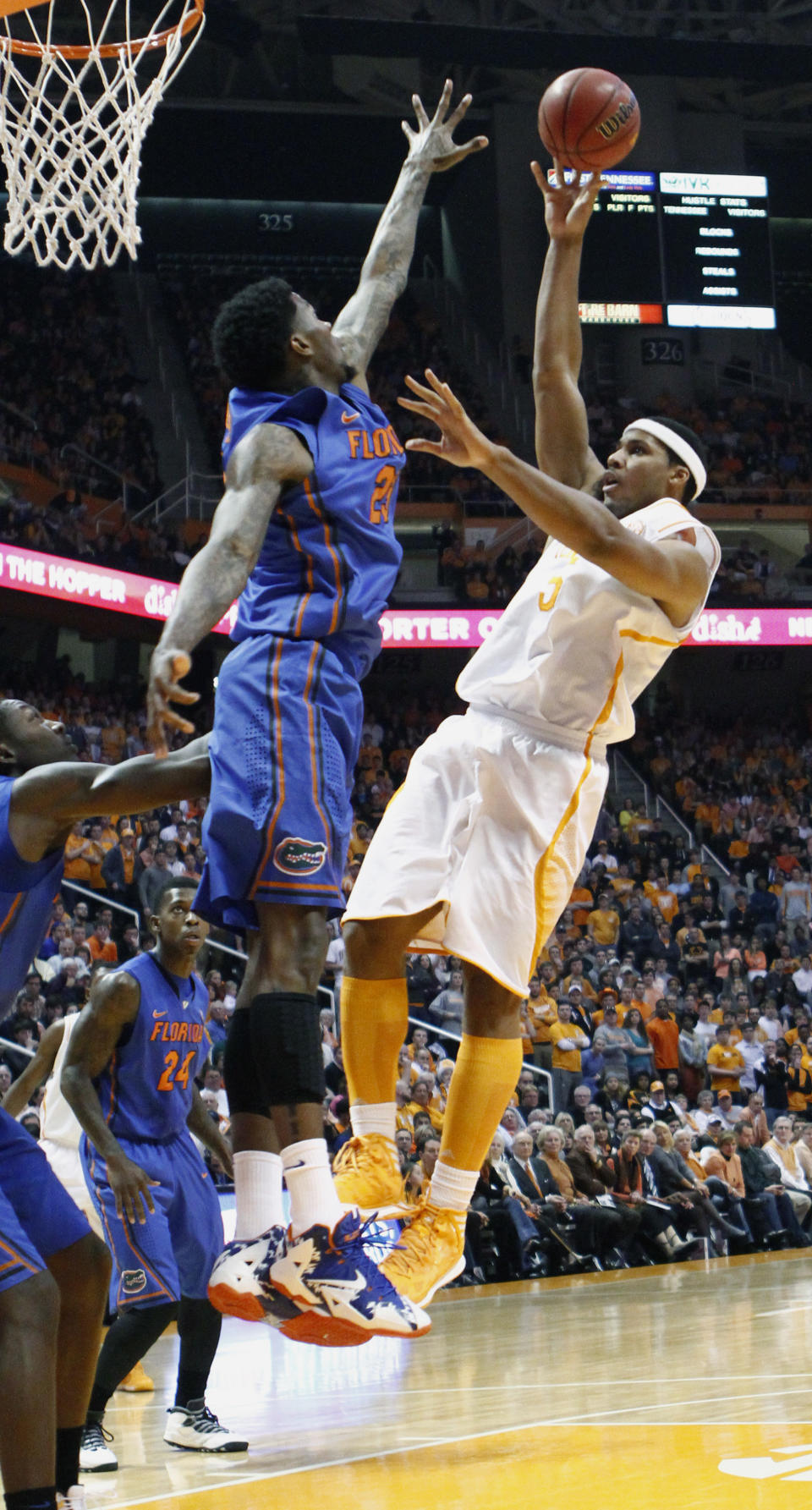 Tennessee forward Jarnell Stokes, right, shoots over Florida forward Casey Prather (24) in the first half of an NCAA college basketball game on Tuesday, Feb. 11, 2014, in Knoxville, Tenn. (AP Photo/Wade Payne)