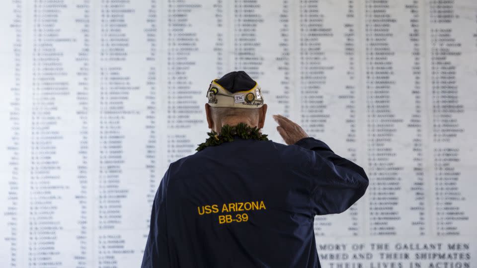 Lou Conter salutes the remembrance wall of the USS Arizona during a memorial service on December 7, 2014, in Pearl Harbor. - Kent Nishimura/Getty Images