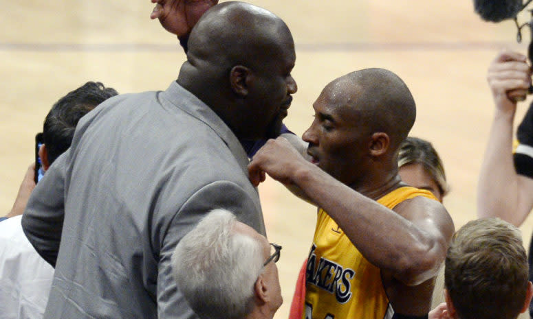Shaquille O'Neal and Kobe Bryant embrace after the star guard's 60 point performance in his final game.