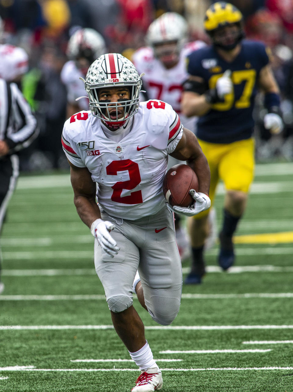 Ohio State running back J.K. Dobbins (2) rushes in the first quarter of an NCAA college football game against Michigan in Ann Arbor, Mich., Saturday, Nov. 30, 2019. (AP Photo/Tony Ding)