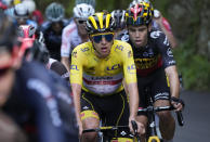 Slovenia's Tadej Pogacar, wearing the overall leader's yellow jersey, and Belgium's Wout Van Aert, right, climb during the eighteenth stage of the Tour de France cycling race over 129.7 kilometers (80.6 miles) with start in Pau and finish in Luz Ardiden, France,Thursday, July 15, 2021. (AP Photo/Christophe Ena)