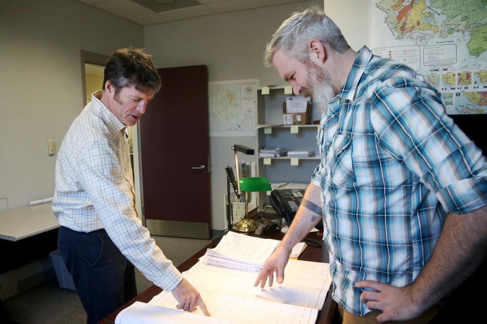 From left, Jason Garnham, Kittery's new planning and development director, discusses blueprints with town planner Jordan Kelley at the Kittery Town Hall on Thursday, Dec. 8.