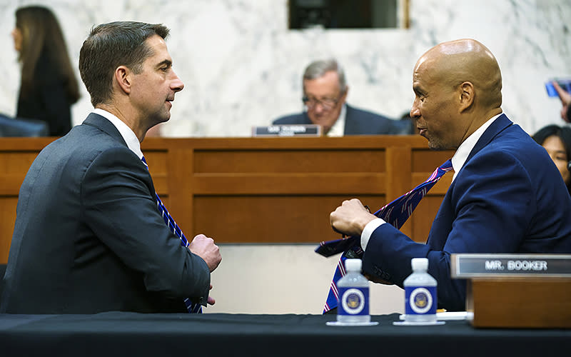 Sen. Tom Cotton (R-Ark.), left, discusses ties with Sen. Cory Booker (D-N.J.) before a Sept. 12 Senate Judiciary Committee hearing entitled “Book Bans: Examining How Censorship Limits Liberty and Literature.” <em>Greg Nash</em>