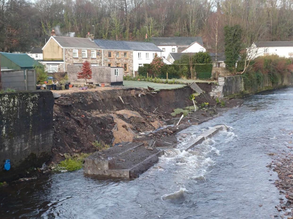 Gardens disappeared into the River Tawe in Ystradgynlais, South Wales. (SWNS)