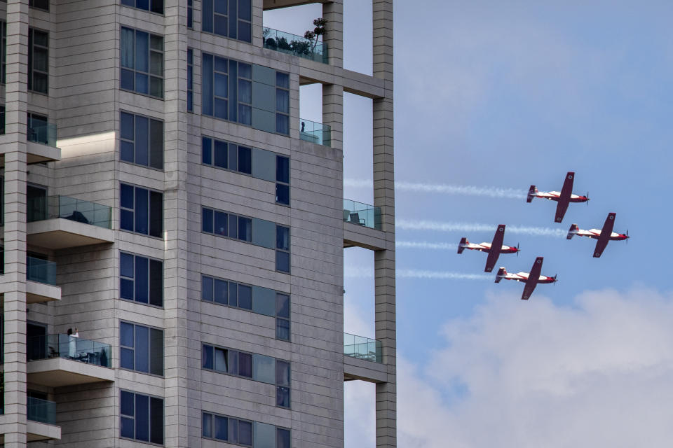 Israeli Air Force aerobatic team flies in formation during celebrations for Israel's 72nd Independence Day, in Tel Aviv, Israel, Wednesday, April 29, 2020. The Israeli government announced a complete lockdown over their Independence Day to control the country's coronavirus outbreak. (AP Photo/Oded Balilty)