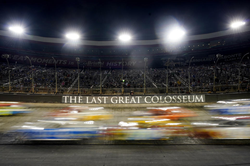 Cars come through a turn during a NASCAR Cup Series auto race at Bristol Motor Speedway Saturday, Sept. 18, 2021, in Bristol, Tenn. (AP Photo/Mark Humphrey)