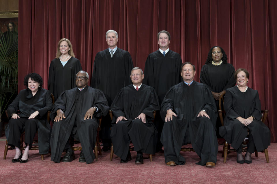 FILE - Members of the Supreme Court sit for a new group portrait following the addition of Associate Justice Ketanji Brown Jackson, at the Supreme Court building in Washington, Oct. 7, 2022. Bottom row, from left, Justice Sonia Sotomayor, Justice Clarence Thomas, Chief Justice of the United States John Roberts, Justice Samuel Alito, and Justice Elena Kagan. Top row, from left, Justice Amy Coney Barrett, Justice Neil Gorsuch, Justice Brett Kavanaugh, and Justice Ketanji Brown Jackson. (AP Photo/J. Scott Applewhite, File)