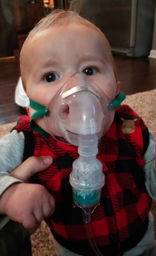 Months after his hospitalization, Beachner requires a nebulizer to assist his breathing. Image via Facebook.