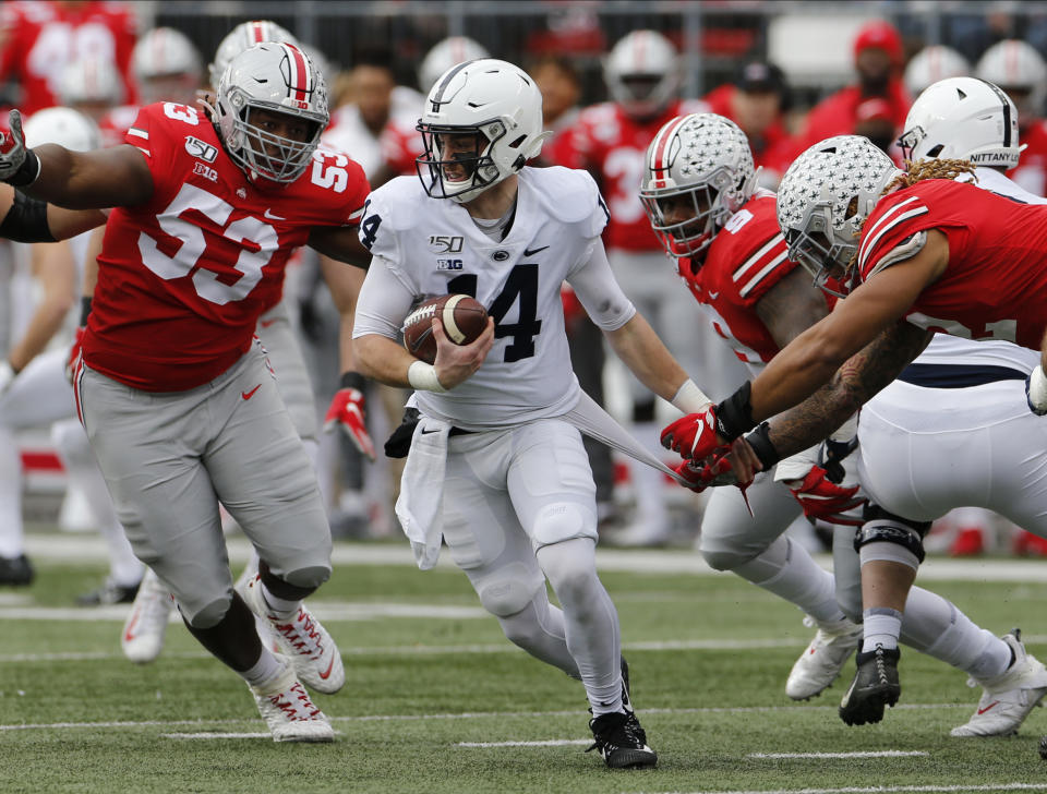 Ohio State defensive lineman Davon Hamilton, left, defensive lineman Taron Vincent, second from right, and defensive end Chase Young, right, put the pressure on Penn State quarterback Sean Clifford during the first half of an NCAA college football game Saturday, Nov. 23, 2019, in Columbus, Ohio. (AP Photo/Jay LaPrete)