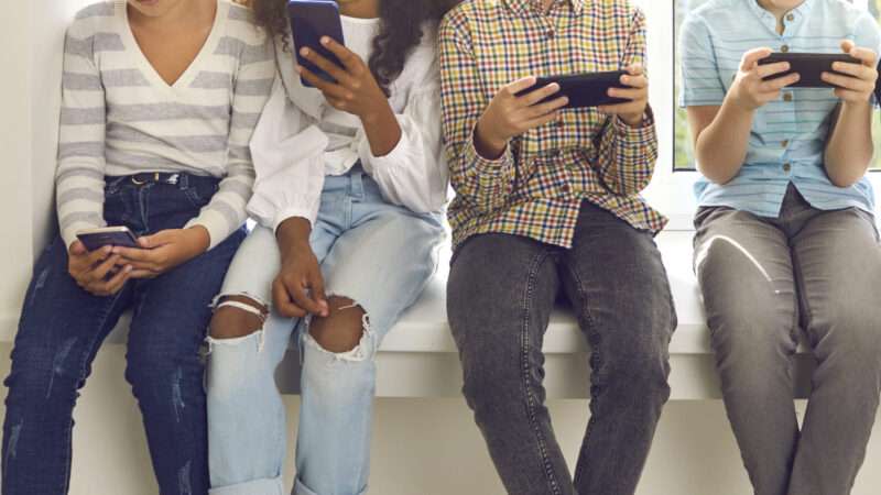 Group of teenagers on their smart phones.