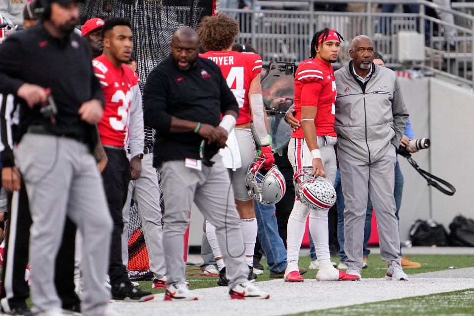 Ohio State athletic director Gene Smith hugs quarterback C.J. Stroud during the Buckeyes' loss to Michigan last year.