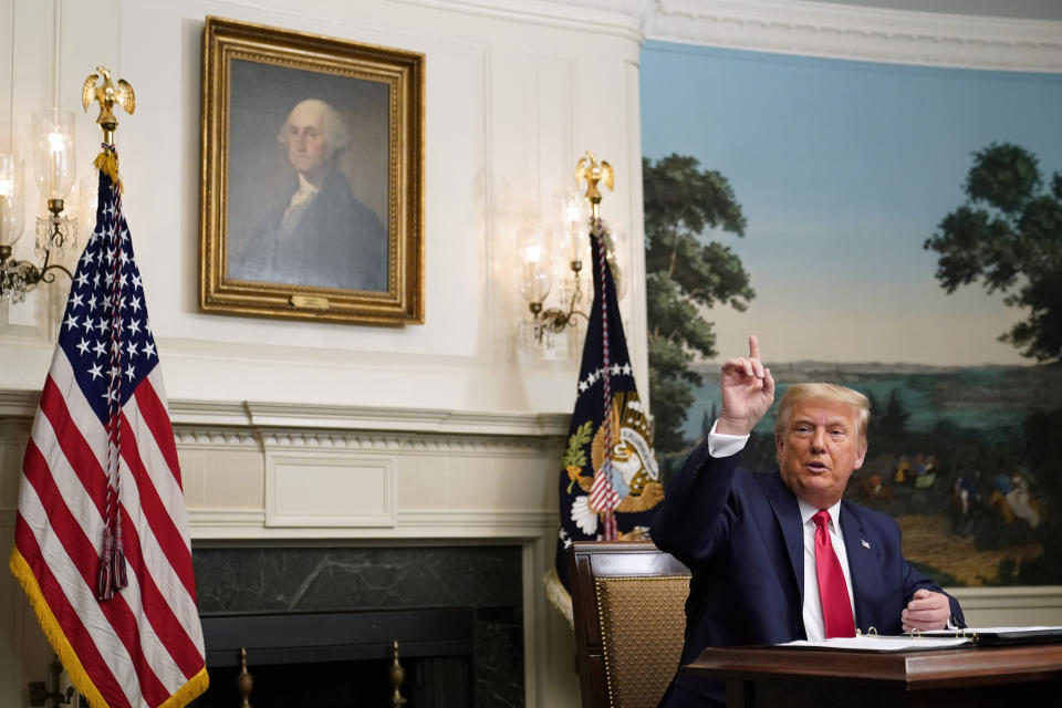 President Donald Trump speaks with reporters after participating in a video teleconference call with members of the military on Thanksgiving, Thursday, Nov. 26, 2020, at the White House in Washington. (AP Photo/Patrick Semansky)