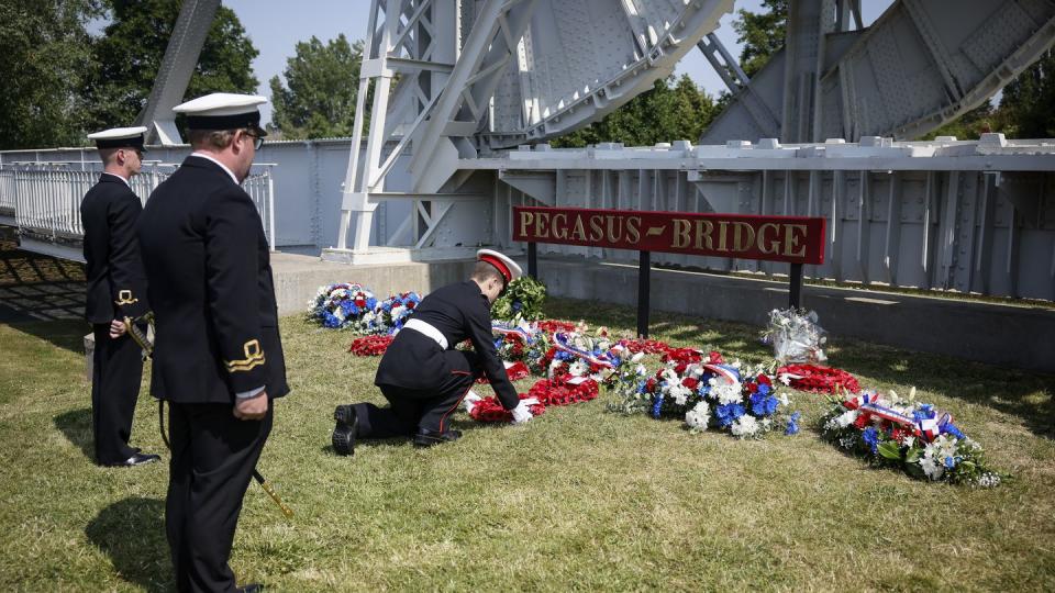 Military officials lay a wreath of flowers at the Pegasus Bridge, one of the first sites liberated by Allied forces from Nazi Germany, in Benouville, Normandy, Monday, June 5, 2023. (Thomas Padilla/AP)