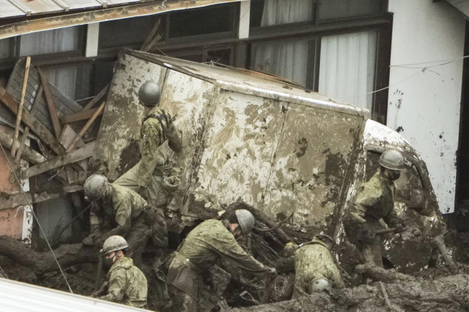 Rescuers continue a search operation at the site of a mudslide at Izusan in Atami, Shizuoka prefecture, southwest of Tokyo Monday, July 5, 2021.(Iori Sagisawa/Kyodo News via AP)