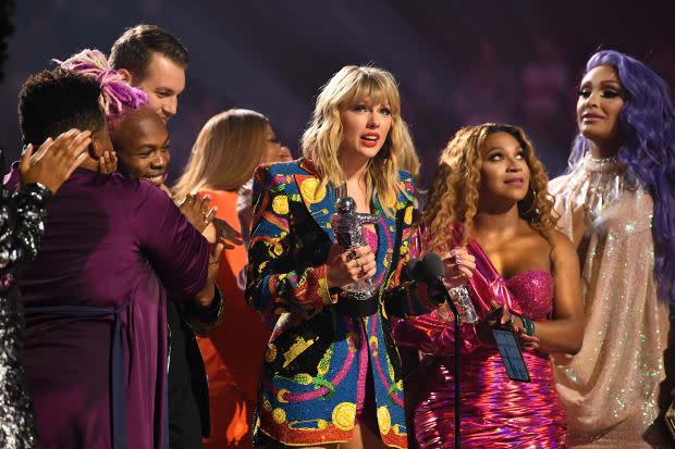 <p> Taylor Swift's then-seemingly new LGBTQIA+ squad members flank her as she accepts the Video of the Year Award at the MTV Video Music Awards on Aug. 26, 2019.</p><p>Dimitrios Kambouris/VMN19/Getty Images for MTV</p>