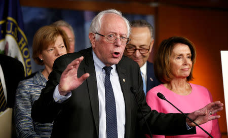 Former Democratic presidential candidate Bernie Sanders speaks to reporters as Senate Democratic Leader Chuck Schumer (2nd R) and House Democratic Leader Nancy Pelosi (R) stand with him following their meeting with U.S. President Barack Obama on congressional Republicans' effort to repeal the Affordable Care Act on Capitol Hill in Washington, U.S., January 4, 2017. REUTERS/Kevin Lamarque