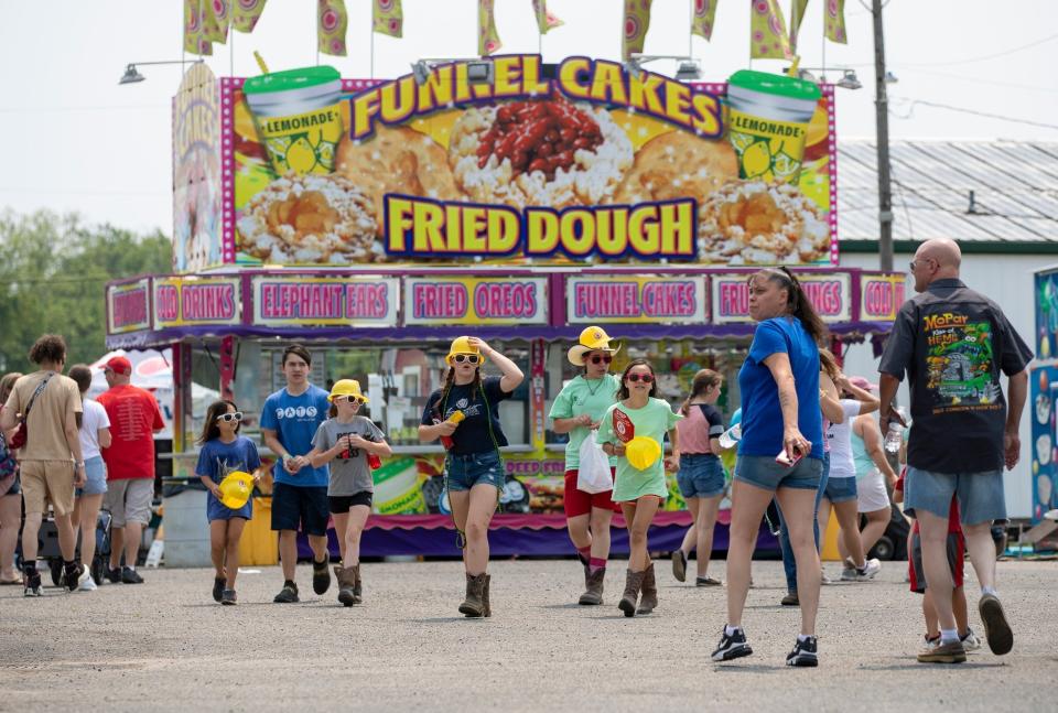 Kids walk through the midway at the Franklin County Fair in Hilliard.