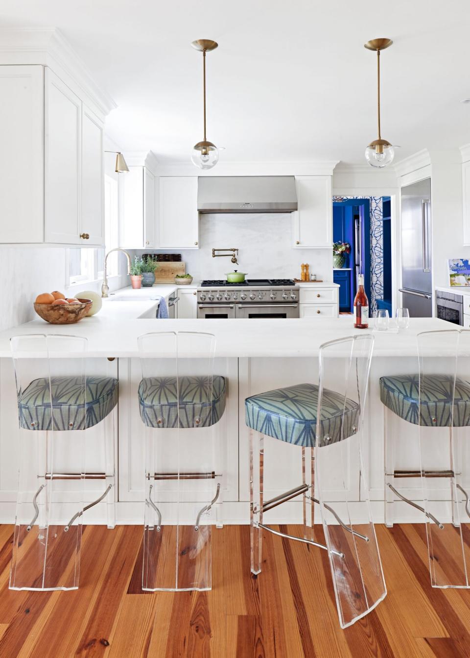 Airy White kitchen with lucite barstools