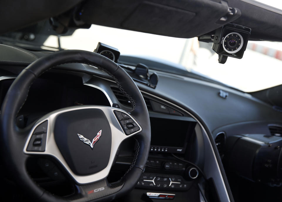 Three pieces of device installed by Arrow Electronics are shown under and next to the visor and on the dashboard in this Corvette, enabling former Indy Racing League driver Sam Schmidt to drive by moving his head to steer, pictured Tuesday, Sept. 27, 2016, in Las Vegas. Centennial, Colorado-based company bought and modified Schmidt’s $80,000 2016 Corvette Z06. It spent an additional six figures on cameras, sensors and computers and even more to add a steering wheel and brake pedals on the passenger side. (AP Photo/Isaac Brekken)