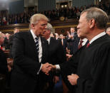 <p>President Donald Trump (L) shakes hands with Chief Justice John Roberts (R) as he arrives to deliver an address to a joint session of the U.S. Congress on February 28, 2017 in the House chamber of the U.S. Capitol in Washington, DC. Trump’s first address to Congress is expected to focus on national security, tax and regulatory reform, the economy, and healthcare. (Jim Lo Scalzo – Pool/Getty Images) </p>