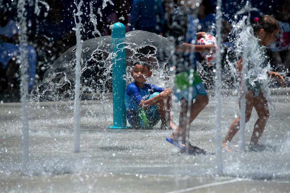 Children play around at Texas State Aquarium's H-E-B Splash Park Thursday, July 6, 2023.