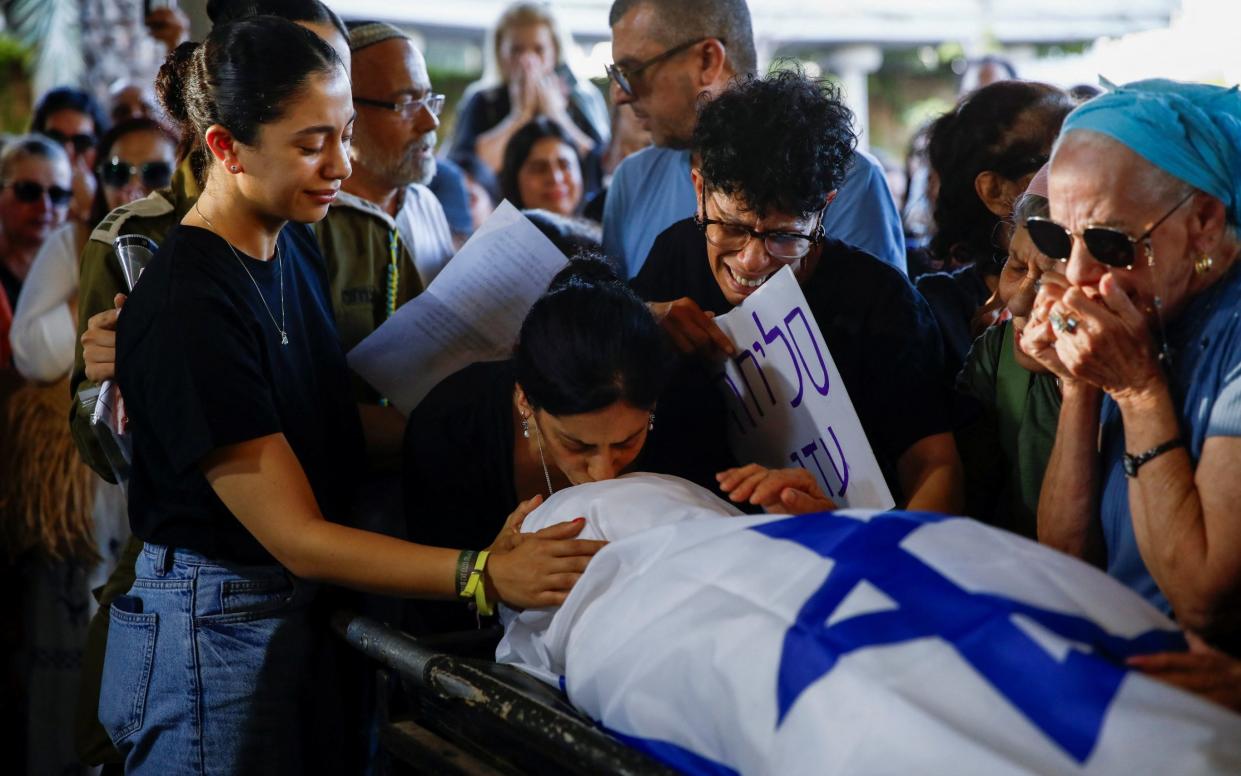 The family of Eden Yerushalmi grieve at her funeral after her body was returned to Israel