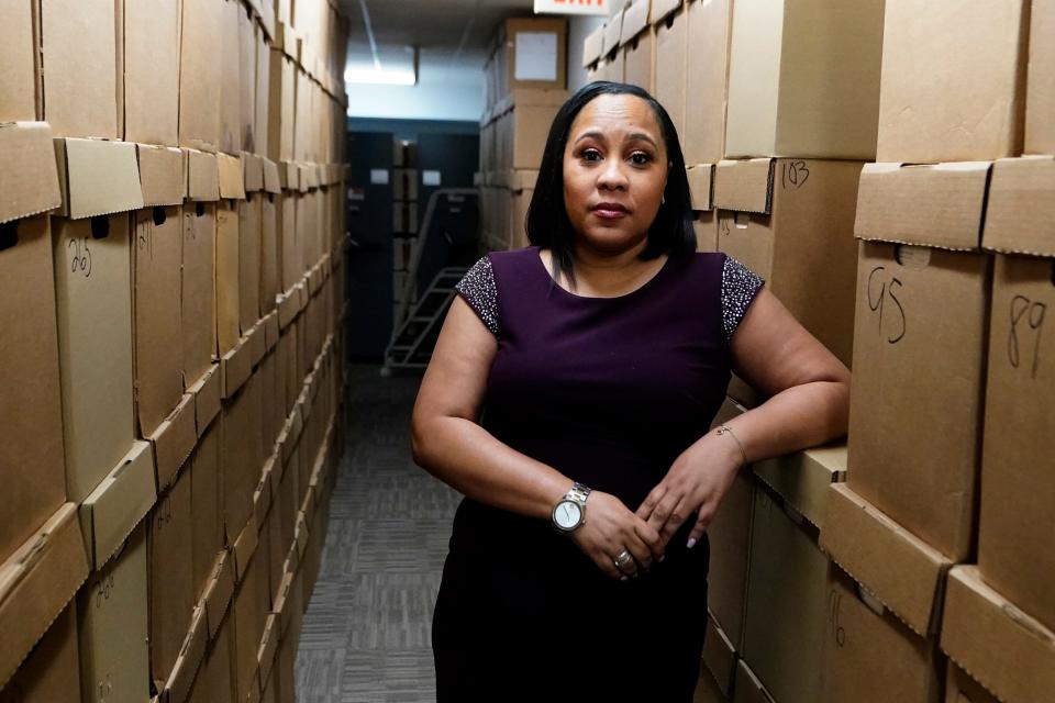 Fulton County District Attorney Fani Willis poses for a photo at her office, Feb. 24, 2021 in Atlanta.  The Georgia prosecutor who’s investigating possible attempts to interfere in the 2020 general election by former President Donald Trump and others has asked for a special grand jury to aid the investigation.  Willis, on Thursday, Jan. 20, 2022, sent a letter to Fulton County Superior Court Chief Judge Christopher Brasher asking him to impanel a special grand jury.