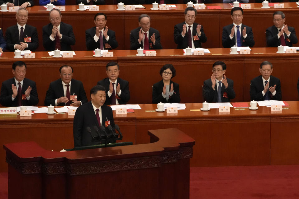 Chinese President Xi Jinping delivers a speech at the closing ceremony as Chinese Premier Li Qiang applauds, top right, during China's National People's Congress (NPC) at the Great Hall of the People in Beijing, Monday, March 13, 2023. (AP Photo/Andy Wong)