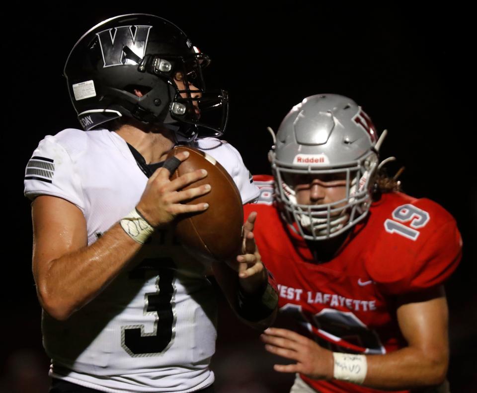 Western Panthers Mitchell Knepley (3) is rushed by West Lafayette Red Devils Valin Hedden (19) during the IHSAA football game, Friday, Sept. 2, 2022, at Gordon Straley Field in West Lafayette, Ind. 