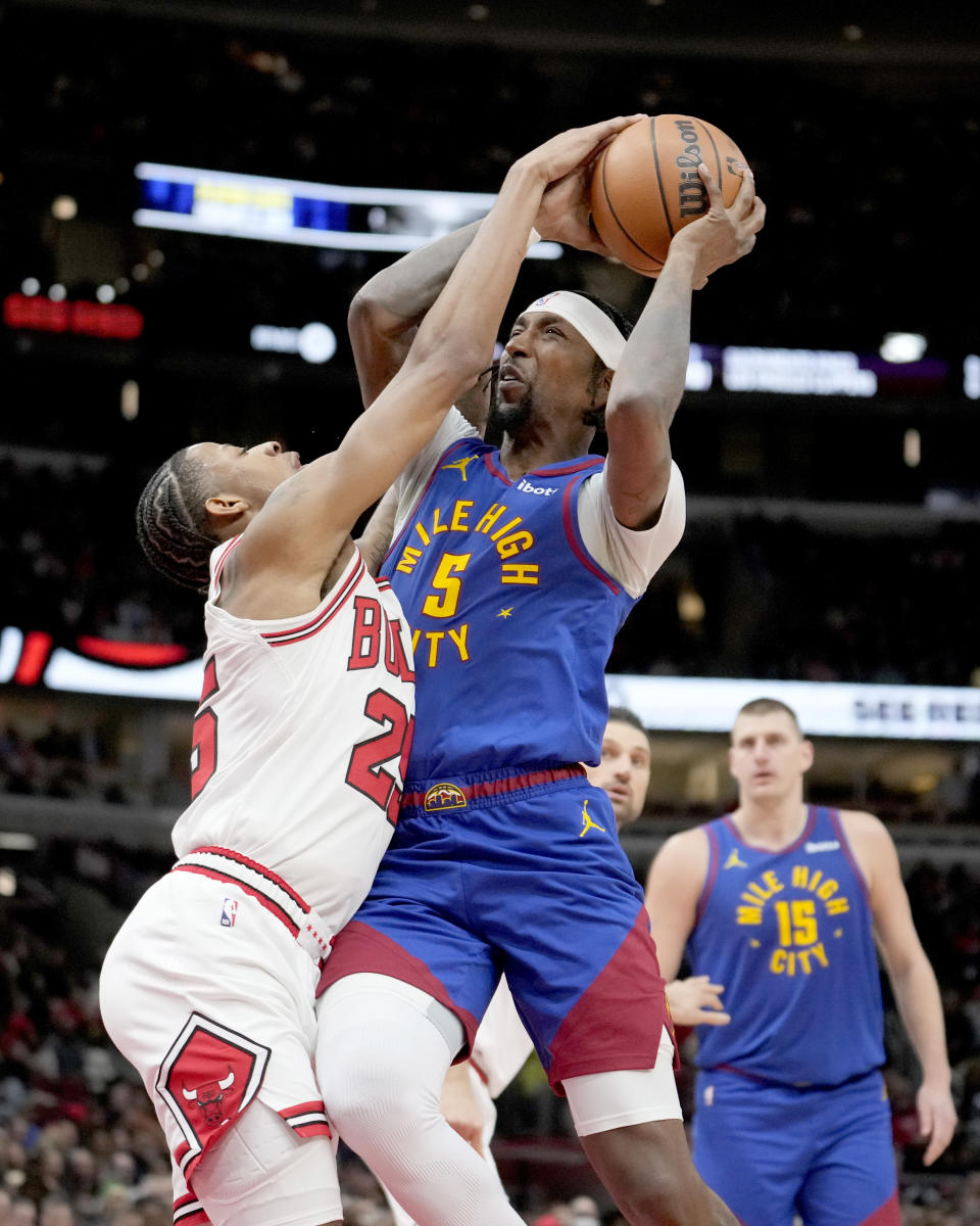 Denver Nuggets guard Kentavious Caldwell-Pope drives to the basket as Chicago Bulls forward Dalen Terry defends during the first half of an NBA basketball game Tuesday, Dec. 12, 2023, in Chicago. (AP Photo/Charles Rex Arbogast)