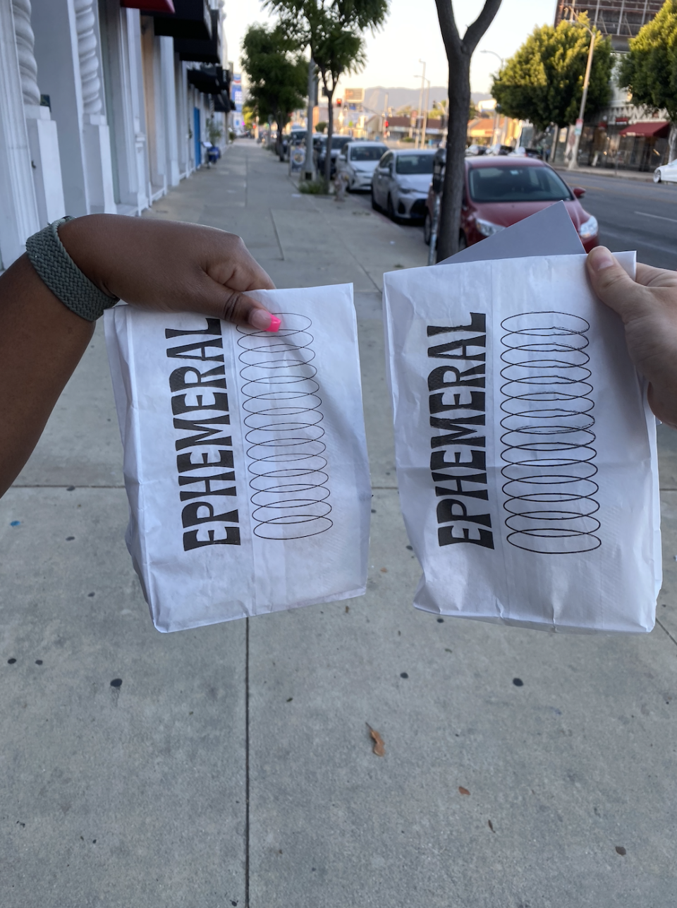 two of the goody bags being held up