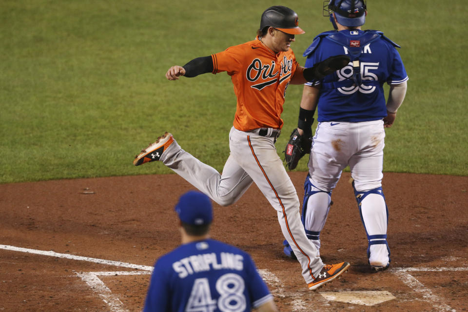 Baltimore Orioles' Austin Hays scores on a double by Jose Iglesias during the eighth inning of the team's baseball game against the Toronto Blue Jays, Saturday, Sept. 26, 2020, in Buffalo, N.Y. (AP Photo/Jeffrey T. Barnes)