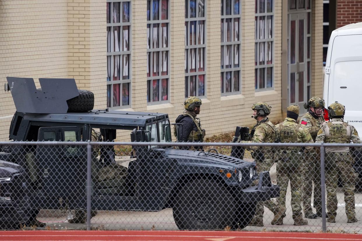 Law enforcement teams stage near Congregation Beth Israel while conducting SWAT operations on Pleasant Run Rd. on Saturday, Jan. 15, 2022, in Colleyville, Texas. Authorities said a man took hostages Saturday during services at the Texas synagogue.