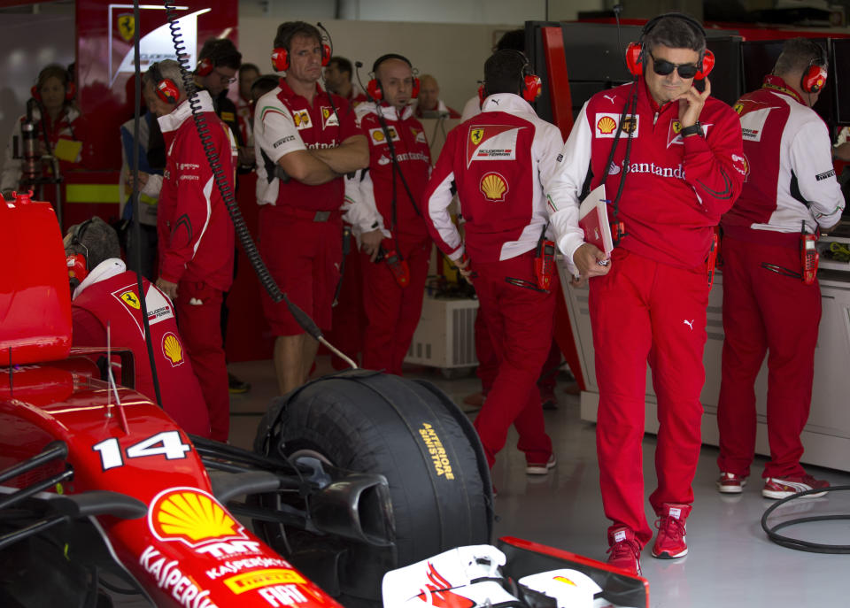 Ferrari's new team principal, Marco Mattiacci, second right, stands at the team garage during the practice session ahead of Sunday's Chinese Formula One Grand Prix at Shanghai International Circuit in Shanghai, China Friday, April 18, 2014. (AP Photo/Andy Wong)