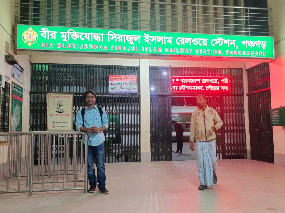 two people in front of a train station in panchagrah Bangladesh