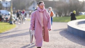 COPENHAGEN, DENMARK - FEBRUARY 01: A guest wears a pink full outfit, sunglasses, a fluffy long oversized blazer jacket , a pullover leather boots , outside Marimekko, during the Copenhagen Fashion Week AW24 on February 01, 2024 in Copenhagen, Denmark. (Photo by Edward Berthelot/Getty Images)